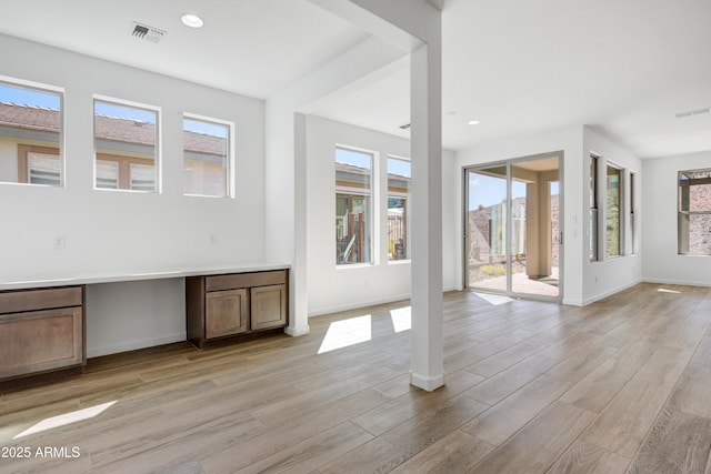 4053 Desert Moon Dr, Wickenburg, AZ 85390 - unfurnished living room featuring plenty of natural light, light wood-type flooring, and recessed lighting