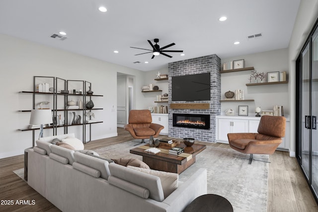 26619 S 169th Pl, Queen Creek, AZ 85142 - living area with a ceiling fan, wood finished floors, a fireplace, and recessed lighting