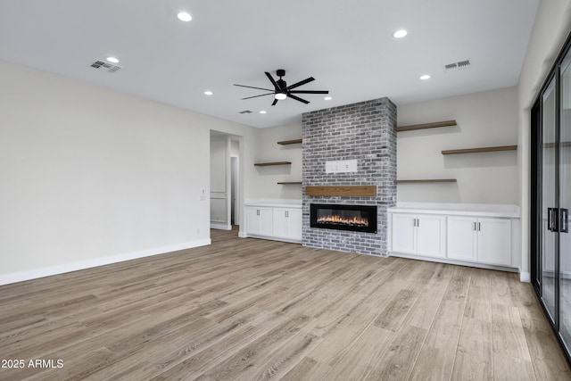 26619 S 169th Pl, Queen Creek, AZ 85142 - unfurnished living room with ceiling fan, light wood-style flooring, a large fireplace, recessed lighting, and baseboards