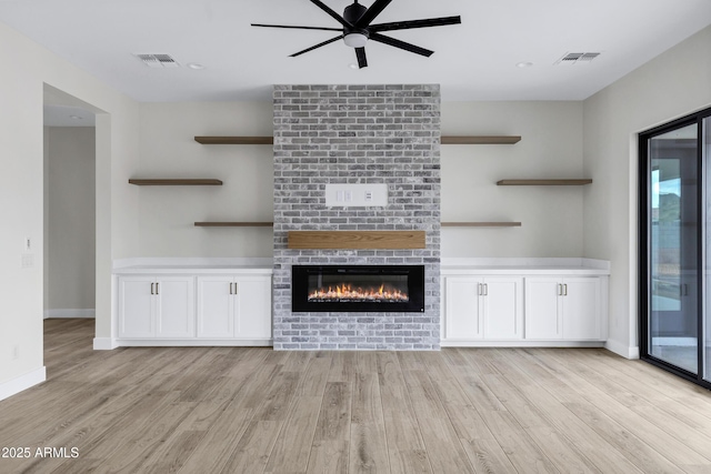 26619 S 169th Pl, Queen Creek, AZ 85142 - unfurnished living room with ceiling fan, light wood-style floors, a brick fireplace, and baseboards