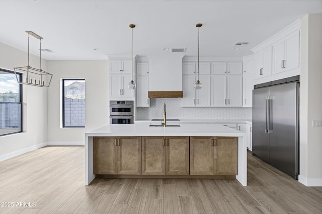26619 S 169th Pl, Queen Creek, AZ 85142 - kitchen featuring stainless steel appliances, light countertops, baseboards, white cabinets, and light wood-style flooring
