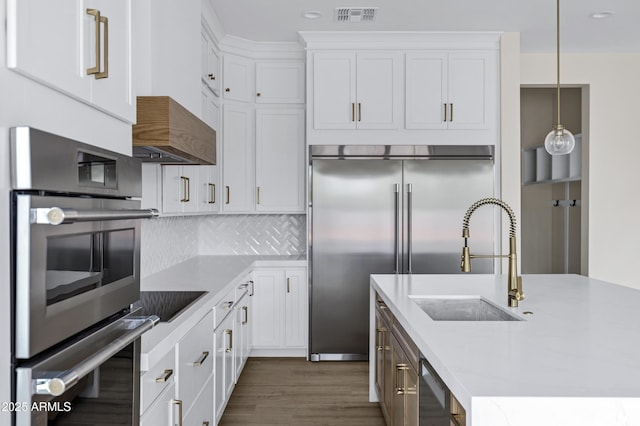 26619 S 169th Pl, Queen Creek, AZ 85142 - kitchen featuring stainless steel appliances, light countertops, white cabinetry, dark wood finished floors, and recessed lighting