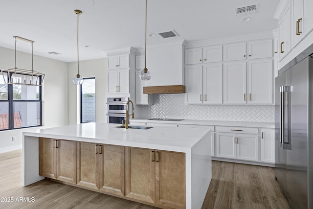 26619 S 169th Pl, Queen Creek, AZ 85142 - kitchen featuring stainless steel appliances, a sink, backsplash, light countertops, and light wood-style flooring