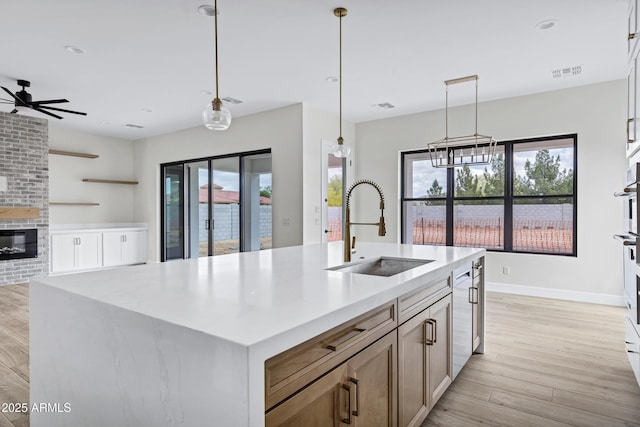 26619 S 169th Pl, Queen Creek, AZ 85142 - kitchen featuring a sink, light wood-style floors, plenty of natural light, hanging light fixtures, and recessed lighting