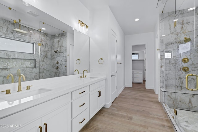 26619 S 169th Pl, Queen Creek, AZ 85142 - bathroom featuring a marble finish shower, double vanity, wood finished floors, recessed lighting, and baseboards