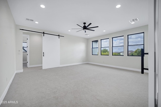 26619 S 169th Pl, Queen Creek, AZ 85142 - unfurnished room with a barn door, a ceiling fan, light colored carpet, recessed lighting, and baseboards