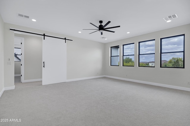 26619 S 169th Pl, Queen Creek, AZ 85142 - empty room with a barn door, a ceiling fan, light carpet, recessed lighting, and baseboards