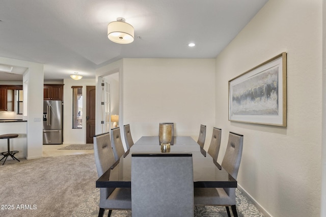 dining space featuring light colored carpet
