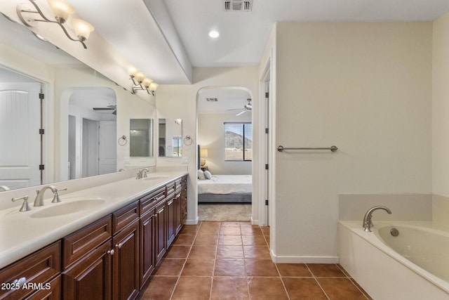 bathroom with baseboards, a sink, ceiling fan, and double vanity