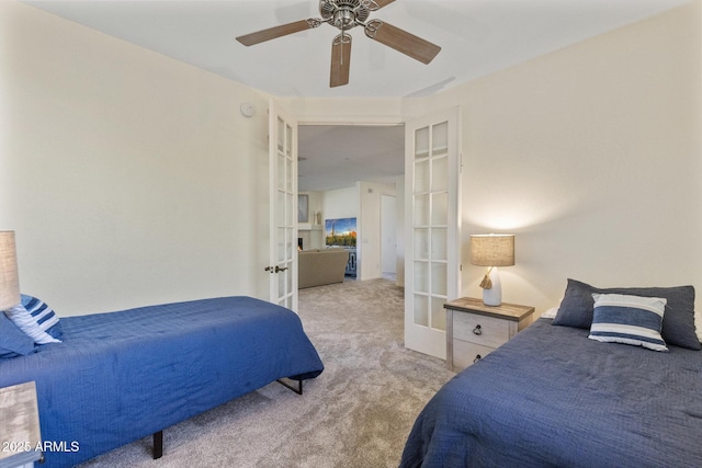bedroom with a ceiling fan, light carpet, and french doors