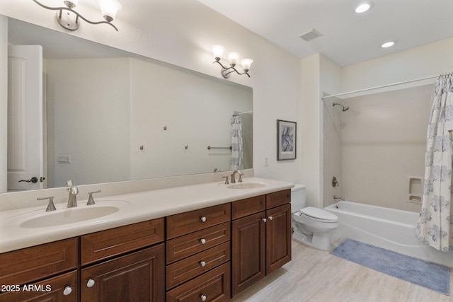 bathroom featuring toilet, shower / bath combination with curtain, a sink, and wood finished floors