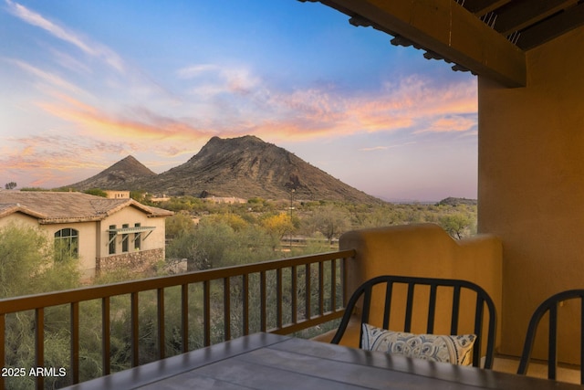 deck at dusk featuring a mountain view