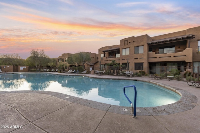 pool featuring fence and a patio area