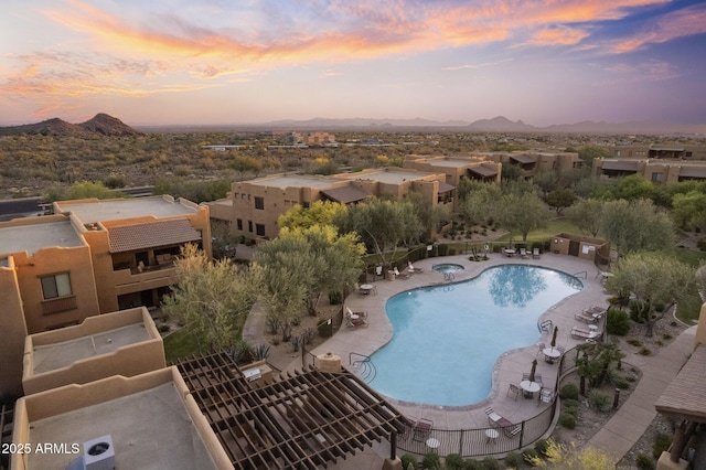 aerial view at dusk featuring a mountain view