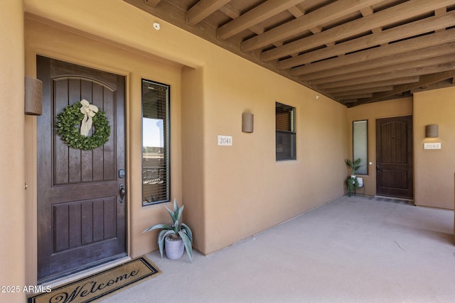 doorway to property with stucco siding