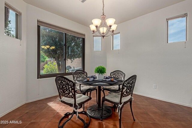 3023 E Silversmith Trl, San Tan Valley, AZ 85143 - tiled dining space featuring an inviting chandelier and baseboards