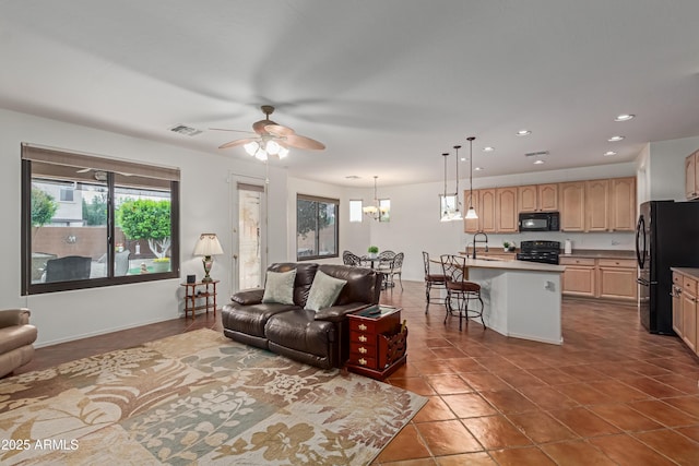 3023 E Silversmith Trl, San Tan Valley, AZ 85143 - tiled living room featuring a sink, visible vents, recessed lighting, and ceiling fan with notable chandelier