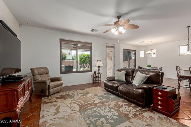 3023 E Silversmith Trl, San Tan Valley, AZ 85143 - tiled living area with visible vents, plenty of natural light, baseboards, and ceiling fan with notable chandelier