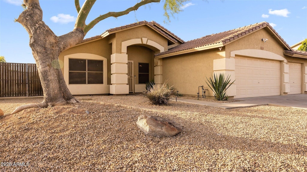 21630 N 30th Ln, Phoenix, AZ 85027 - mediterranean / spanish home featuring a tiled roof, an attached garage, and stucco siding
