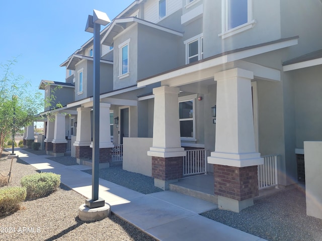 view of home's exterior featuring covered porch and stucco siding