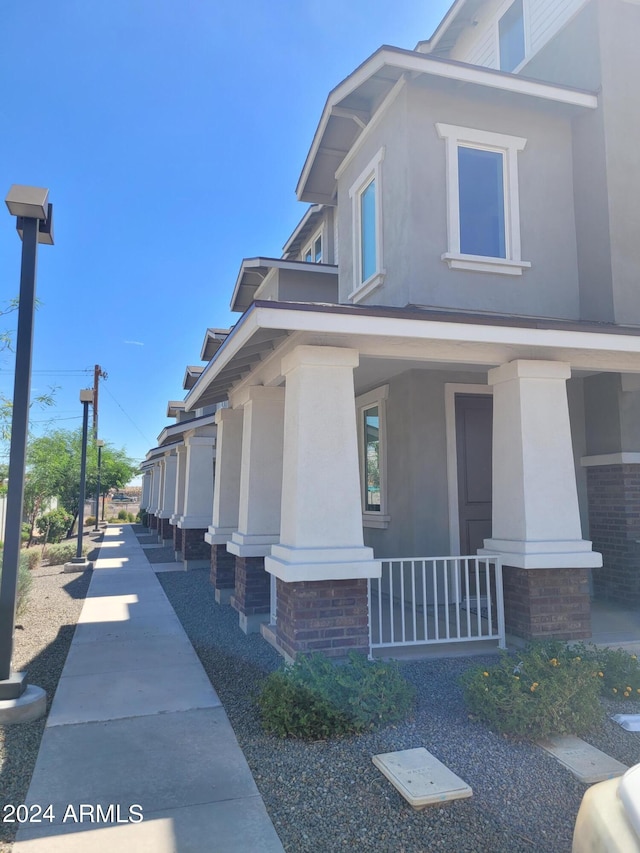 view of property exterior featuring a porch and stucco siding