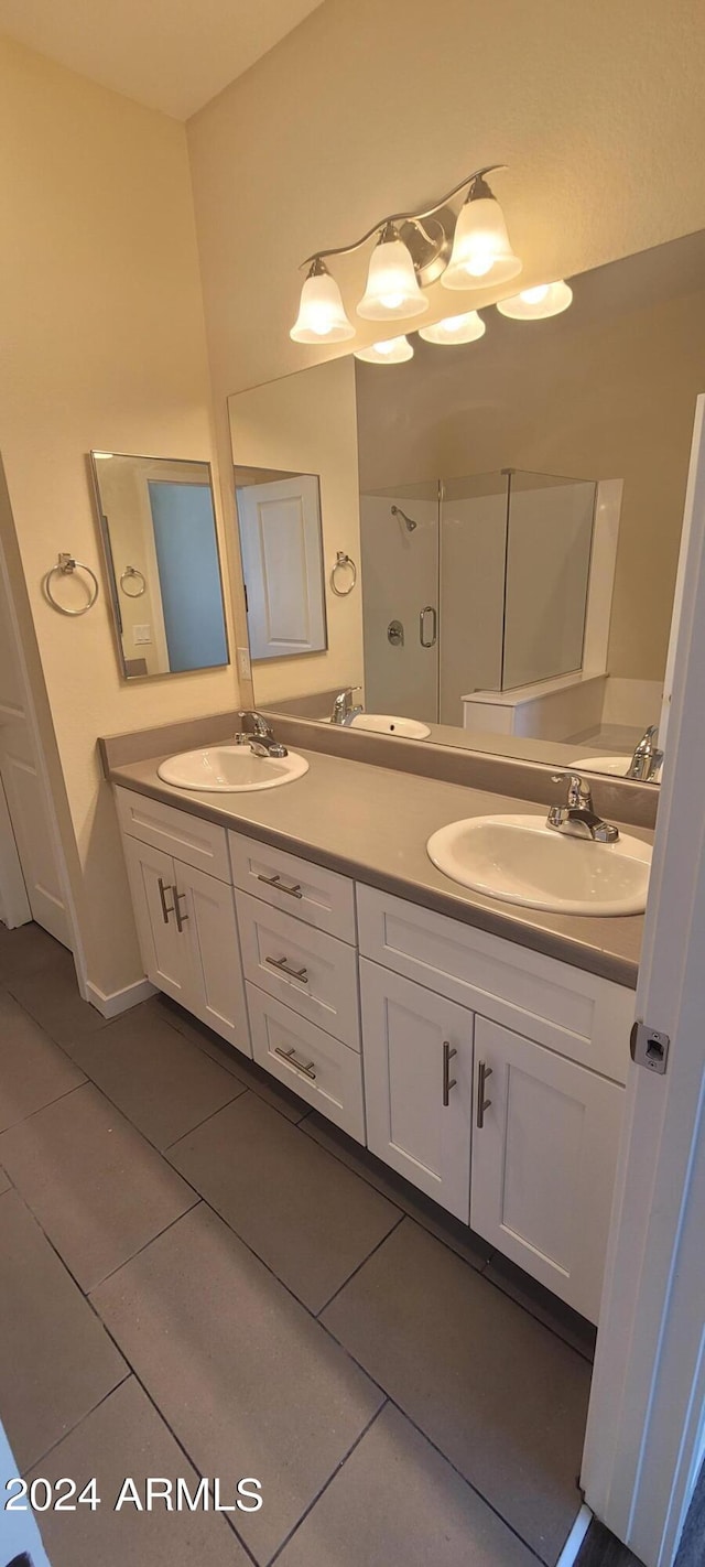 bathroom featuring double vanity, tile patterned flooring, and a sink