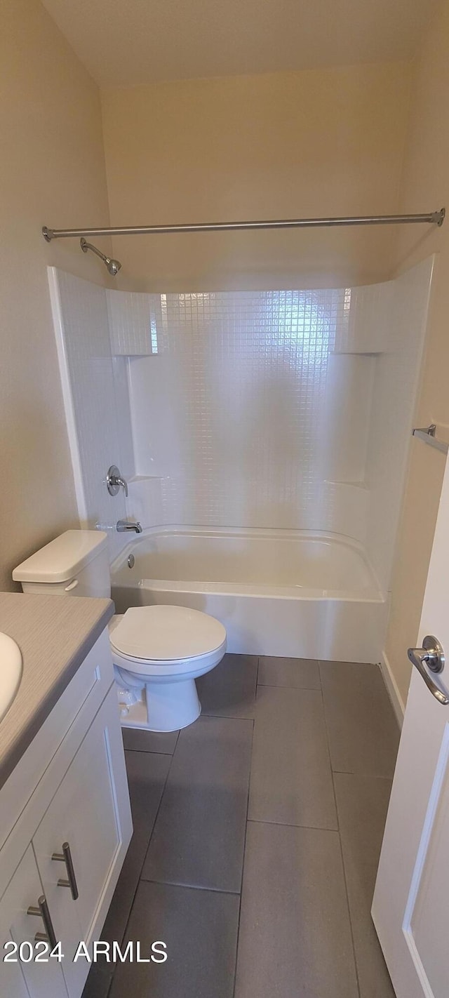 bathroom with shower / washtub combination, vanity, toilet, and tile patterned floors