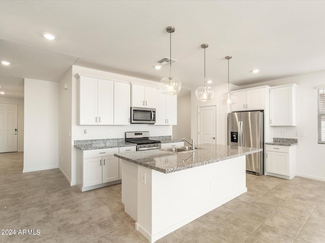 kitchen featuring a center island with sink, sink, white cabinets, and stainless steel appliances