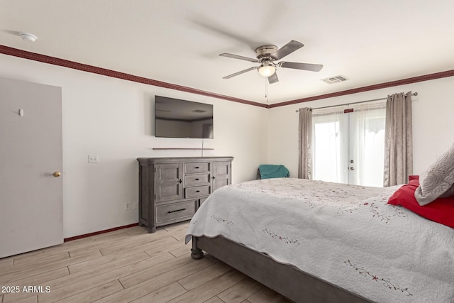 bedroom featuring baseboards, ceiling fan, light wood-style flooring, and crown molding