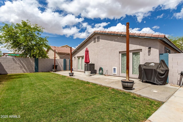 back of house featuring a patio, a fenced backyard, stucco siding, french doors, and a yard