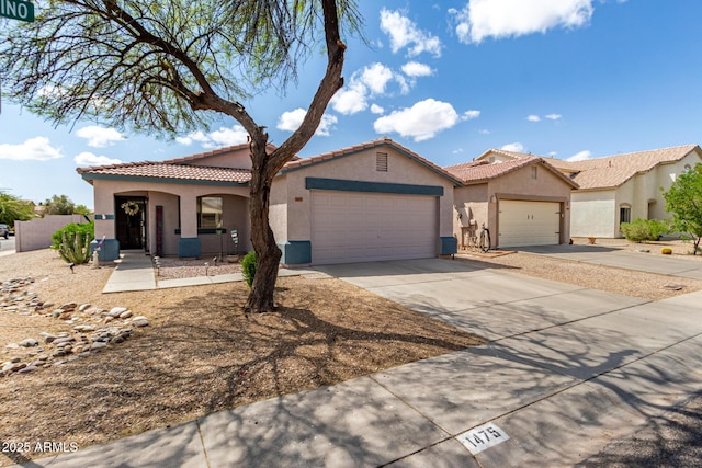 mediterranean / spanish-style home with a tile roof, a garage, driveway, and stucco siding