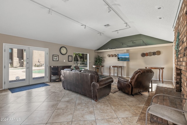 living room with french doors, vaulted ceiling, rail lighting, and light tile patterned floors