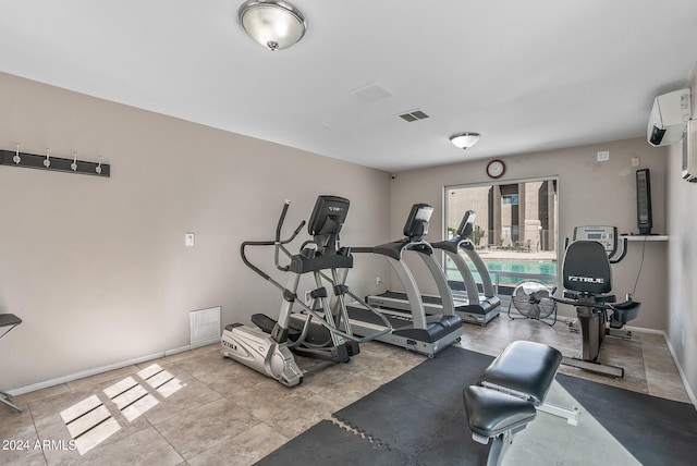 exercise room featuring a wall unit AC and a pool