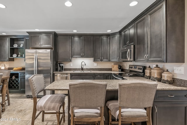 kitchen featuring appliances with stainless steel finishes, dark brown cabinetry, and sink