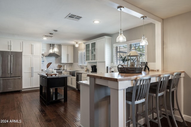 kitchen featuring stainless steel appliances, tasteful backsplash, visible vents, glass insert cabinets, and dark wood-type flooring