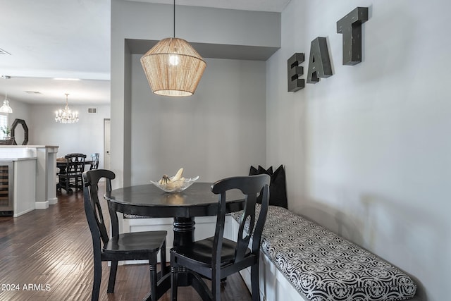 dining room with beverage cooler, visible vents, a chandelier, and dark wood-style flooring