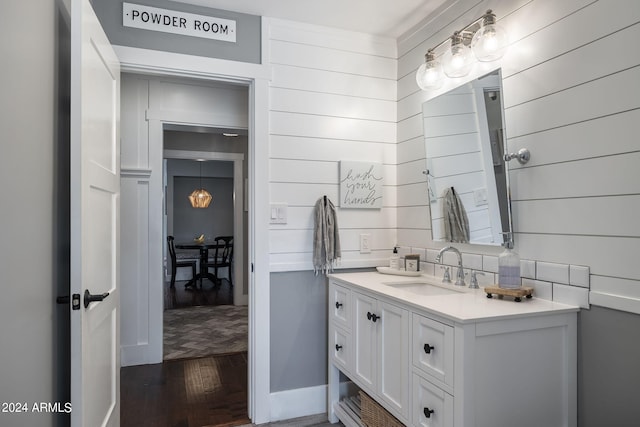 bathroom with wood finished floors and vanity