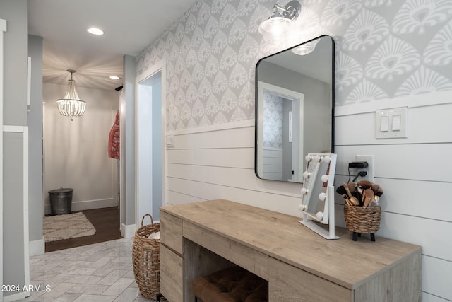 bathroom featuring wallpapered walls, recessed lighting, an inviting chandelier, and wainscoting