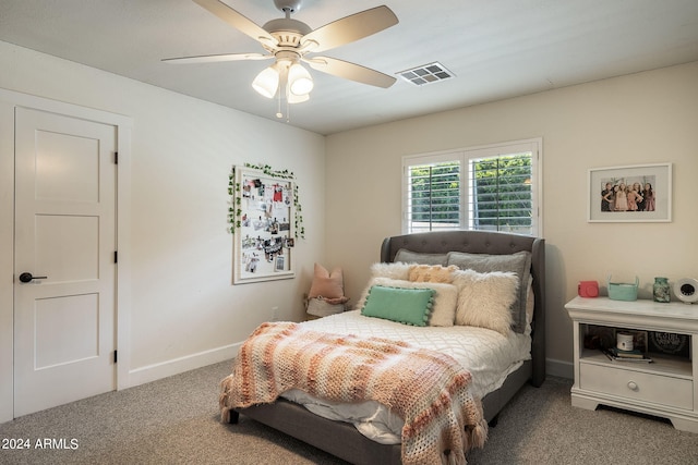 carpeted bedroom with a ceiling fan, visible vents, and baseboards