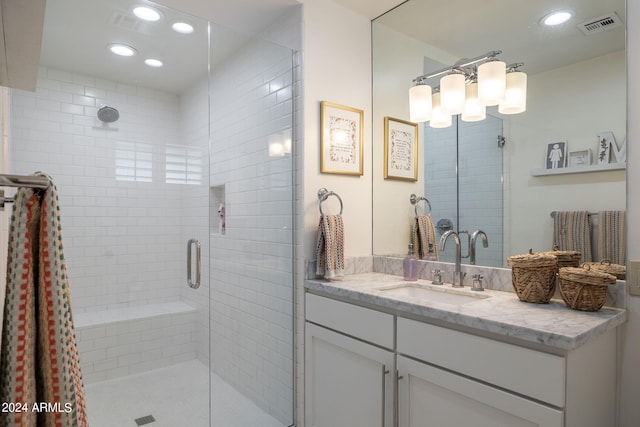 bathroom with recessed lighting, visible vents, a shower stall, and vanity