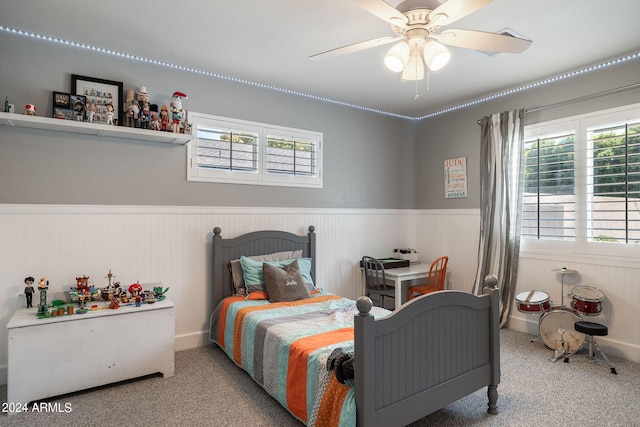 carpeted bedroom featuring wainscoting