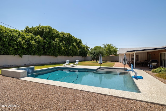 view of swimming pool with a lawn, a fenced in pool, a fenced backyard, a grill, and a patio area