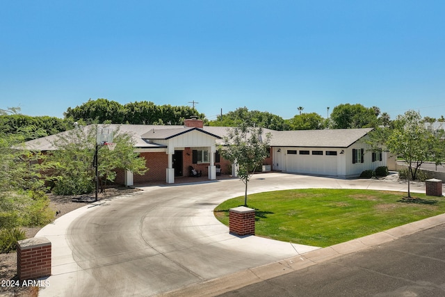 ranch-style house with driveway, a garage, roof with shingles, board and batten siding, and a front yard