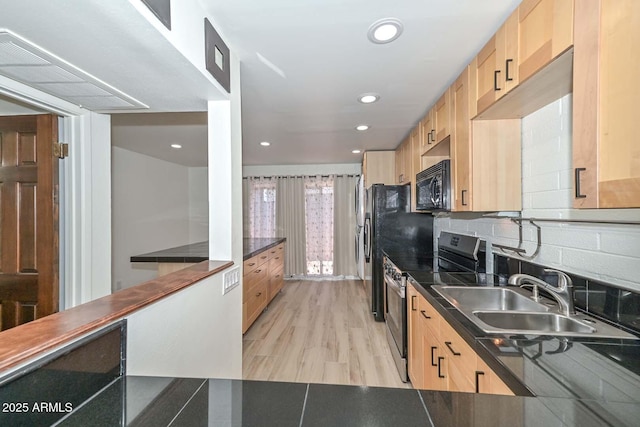 3637 E Monterosa St Unit 8, Phoenix, AZ 85018 - kitchen featuring stainless steel range with electric cooktop, black microwave, light brown cabinets, dark countertops, and recessed lighting
