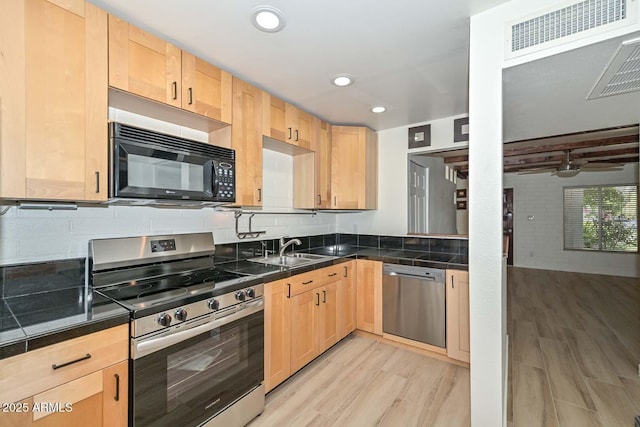 3637 E Monterosa St Unit 8, Phoenix, AZ 85018 - kitchen featuring stainless steel appliances, light brown cabinets, dark countertops, light wood finished floors, and recessed lighting