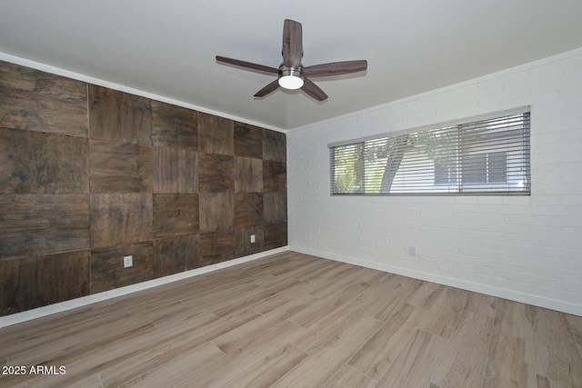 3637 E Monterosa St Unit 8, Phoenix, AZ 85018 - spare room with a ceiling fan, light wood-type flooring, and brick wall