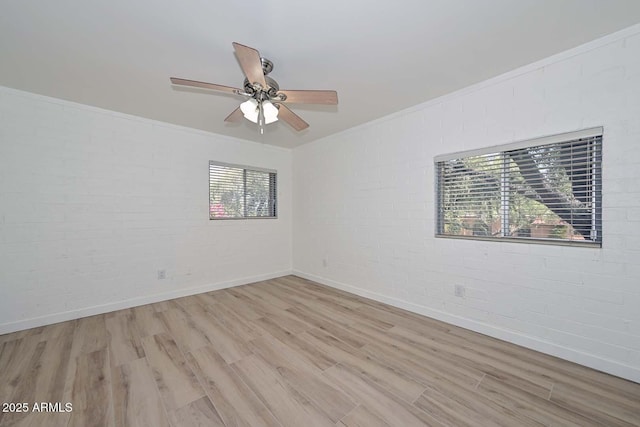 3637 E Monterosa St Unit 8, Phoenix, AZ 85018 - empty room featuring brick wall, light wood-style floors, a ceiling fan, and crown molding