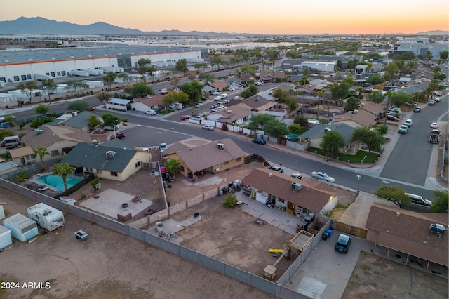 aerial view at dusk featuring a mountain view