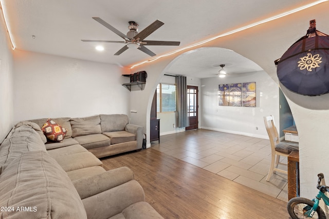 living room featuring ceiling fan and hardwood / wood-style flooring