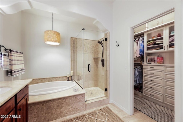 bathroom with plus walk in shower, vanity, and tile patterned floors